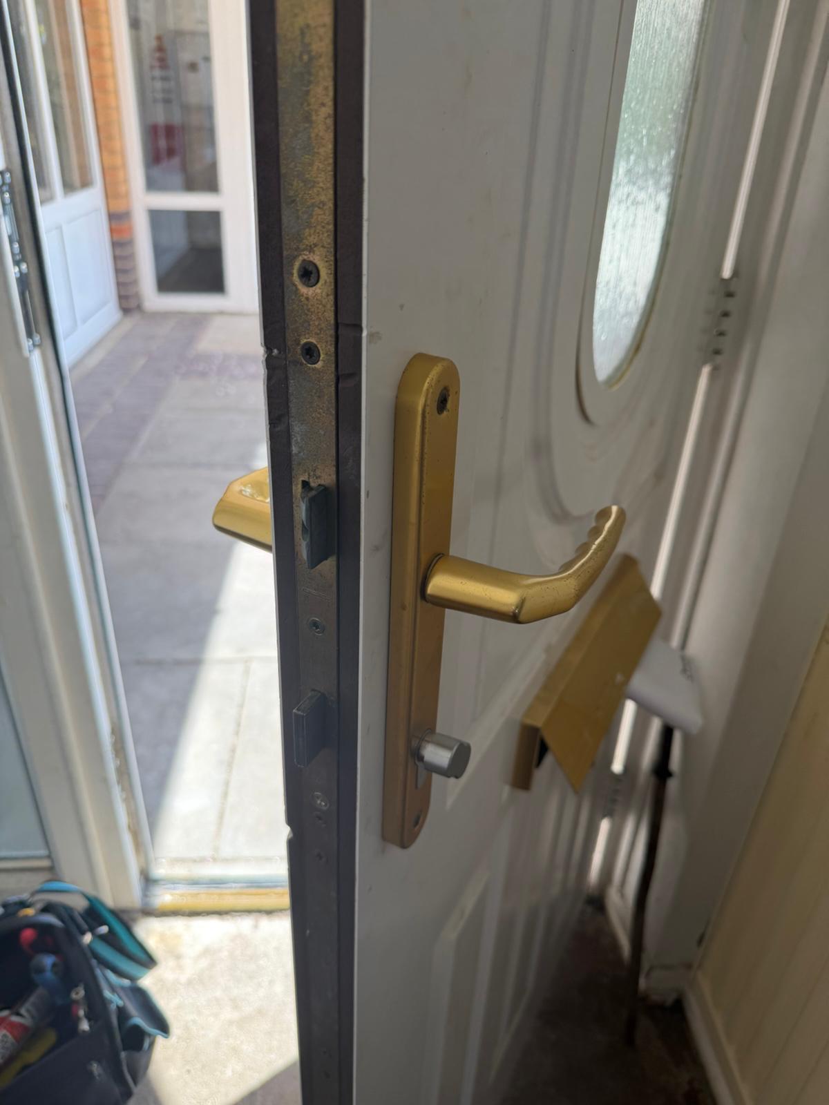 uPVC front door multi-point lock and gold lever handle ready for cylinder change