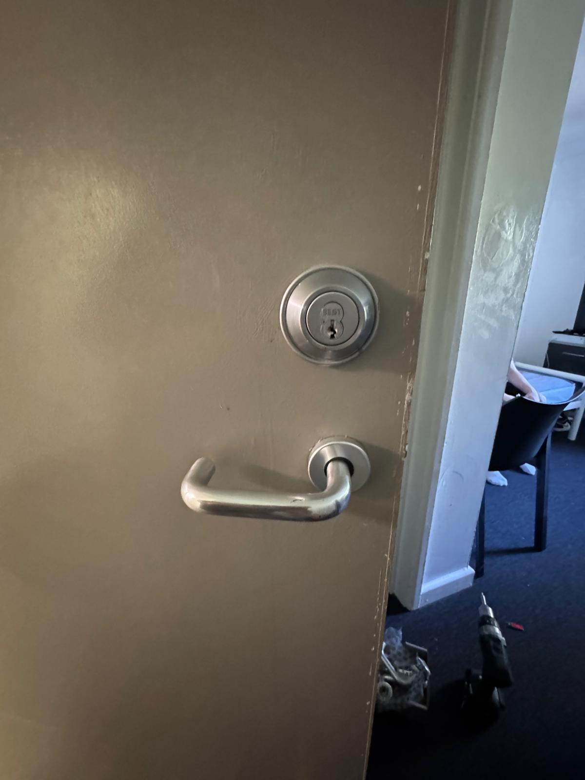 Commercial office steel door fitted with high-security cylinder lock and lever handle