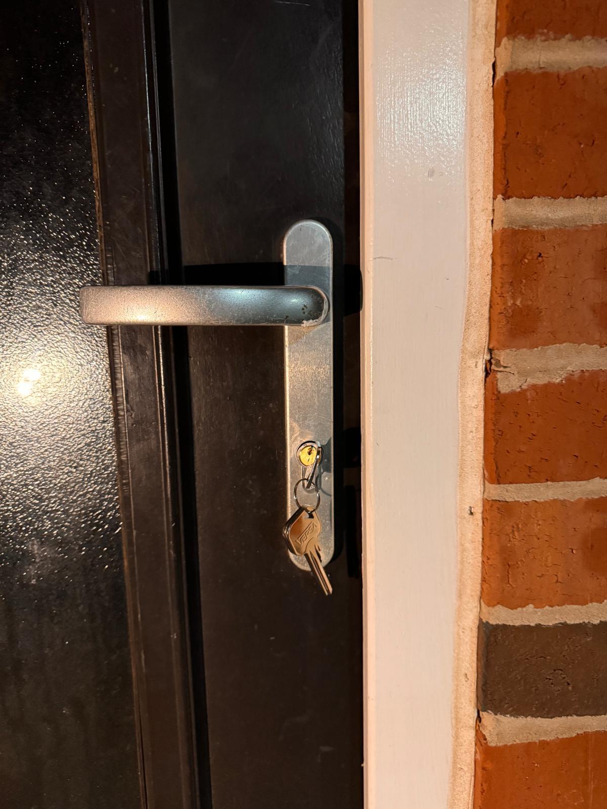 New brushed steel handle and key on a dark composite front door, Middlesbrough