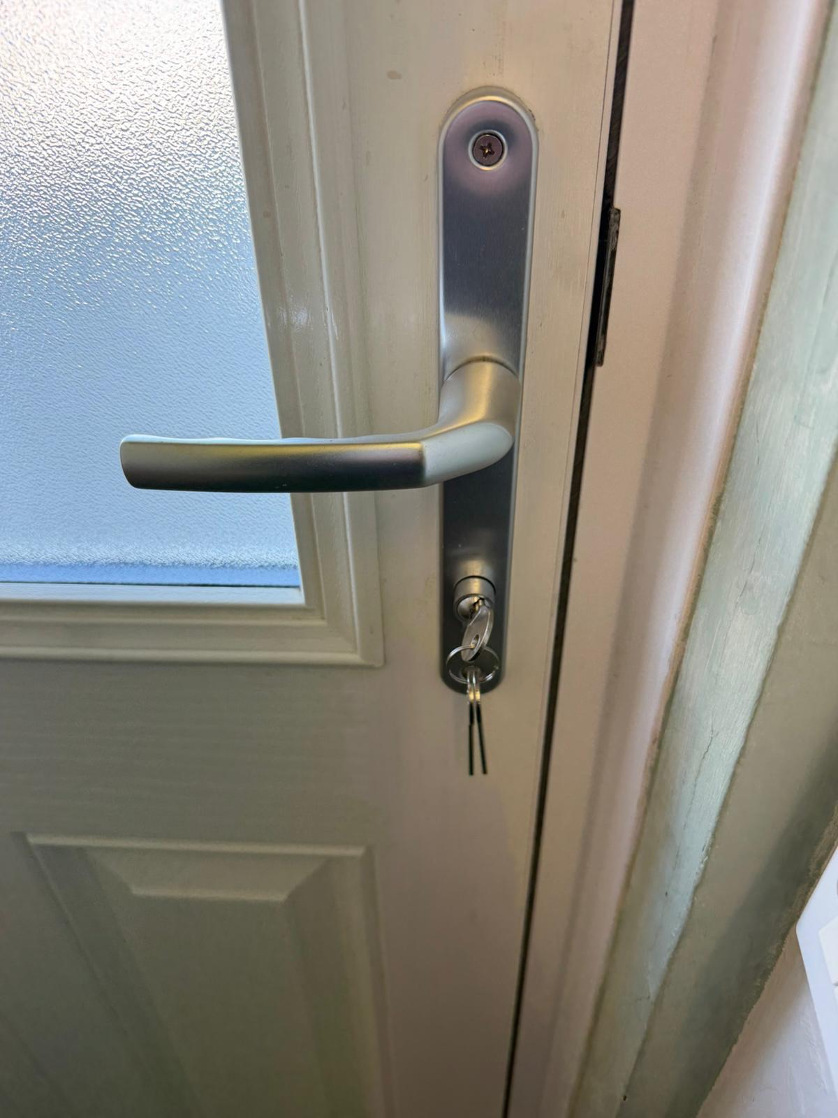 Brushed silver lever handle with new keyed-alike euro cylinder on a composite door